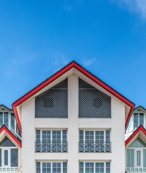 a building with red and white trim and windows at The 