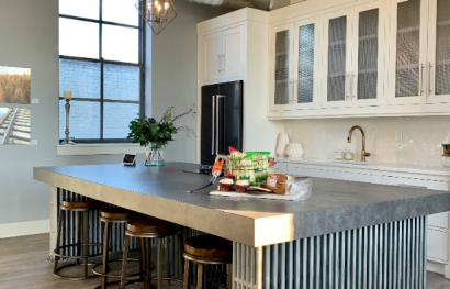 a kitchen with a large island and bar stools at The 