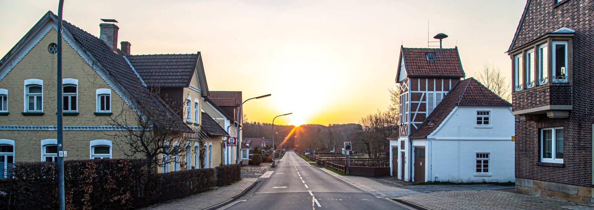 a street with houses on it at sunset at The 