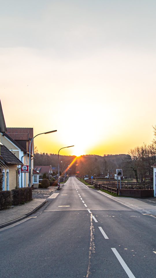 a street with houses on it at sunset at The 